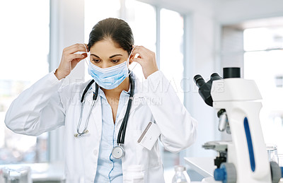 Buy stock photo Woman, doctor and mask with microscope for biology, forensic science or medical discovery at laboratory. Female person, biologist or scientist with protection for virus, health and safety at lab