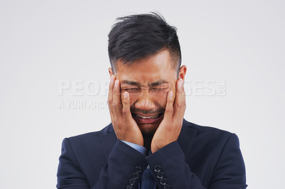 Buy stock photo Crying, stress or sad businessman in studio with anxiety, worry or debt risk on grey background. Pain, sorrow or emotional Asian banker frustrated by fear, depression or grief with loss or bad news