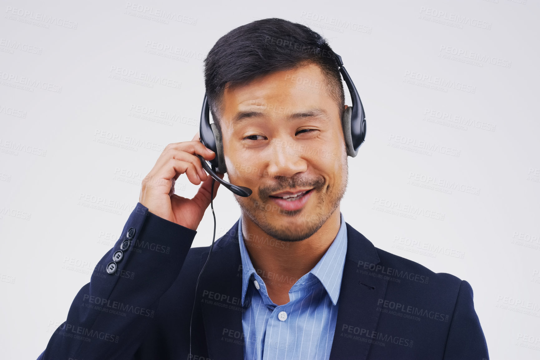 Buy stock photo Talking, call center and Asian man in studio with thinking, headset and happy on white background. Male person, consultant and advisor for support, information and crm with mic for communication