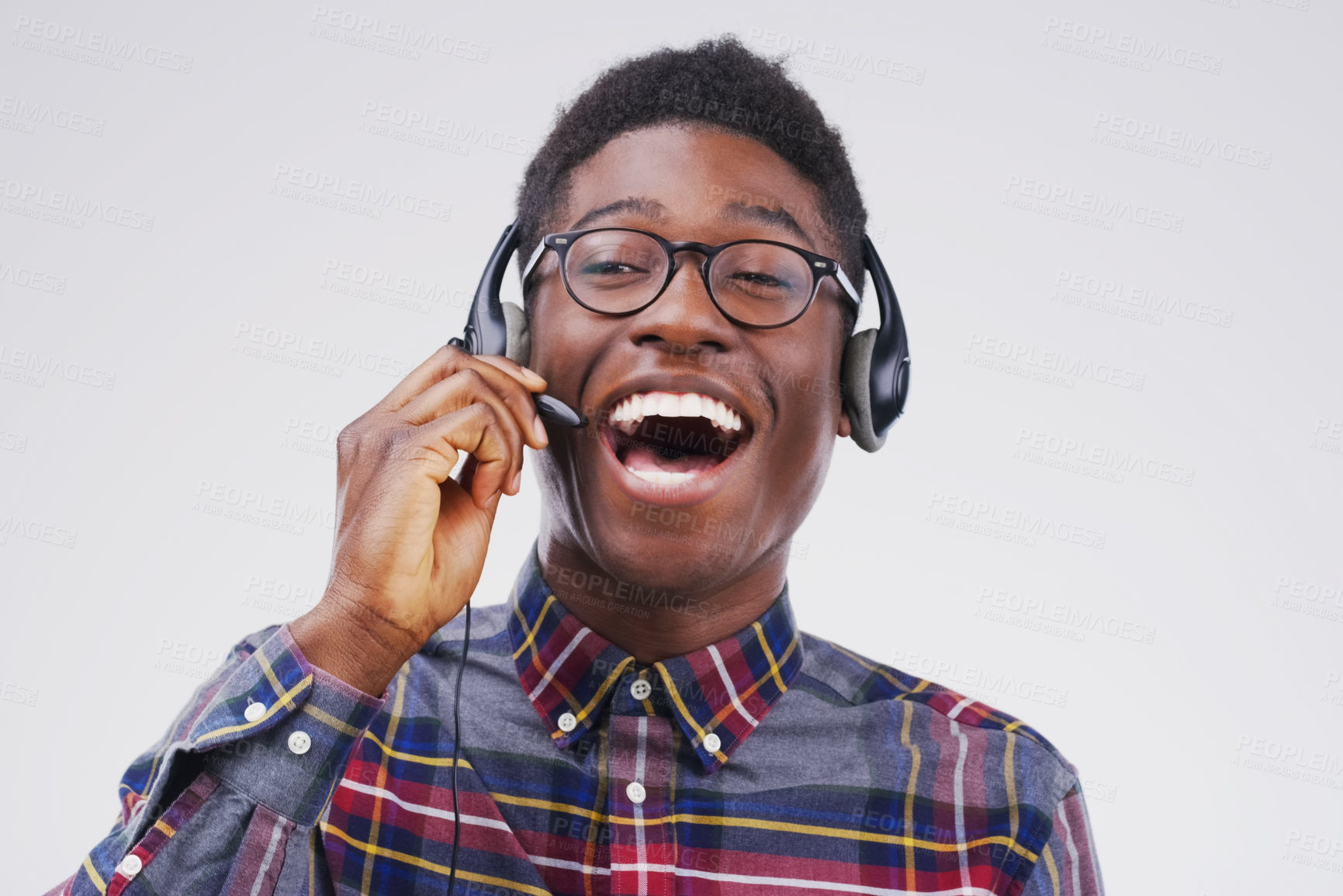 Buy stock photo African man, laugh and studio with headphones for customer service or call center, smile for communication. Male person, white background and microphone with happiness for chat or telemarketing