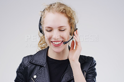 Buy stock photo Call center, woman and listening in studio with headset, smile or thinking for tech support by white background. Crm girl, telemarketing and help desk with microphone, voip and happy for consulting