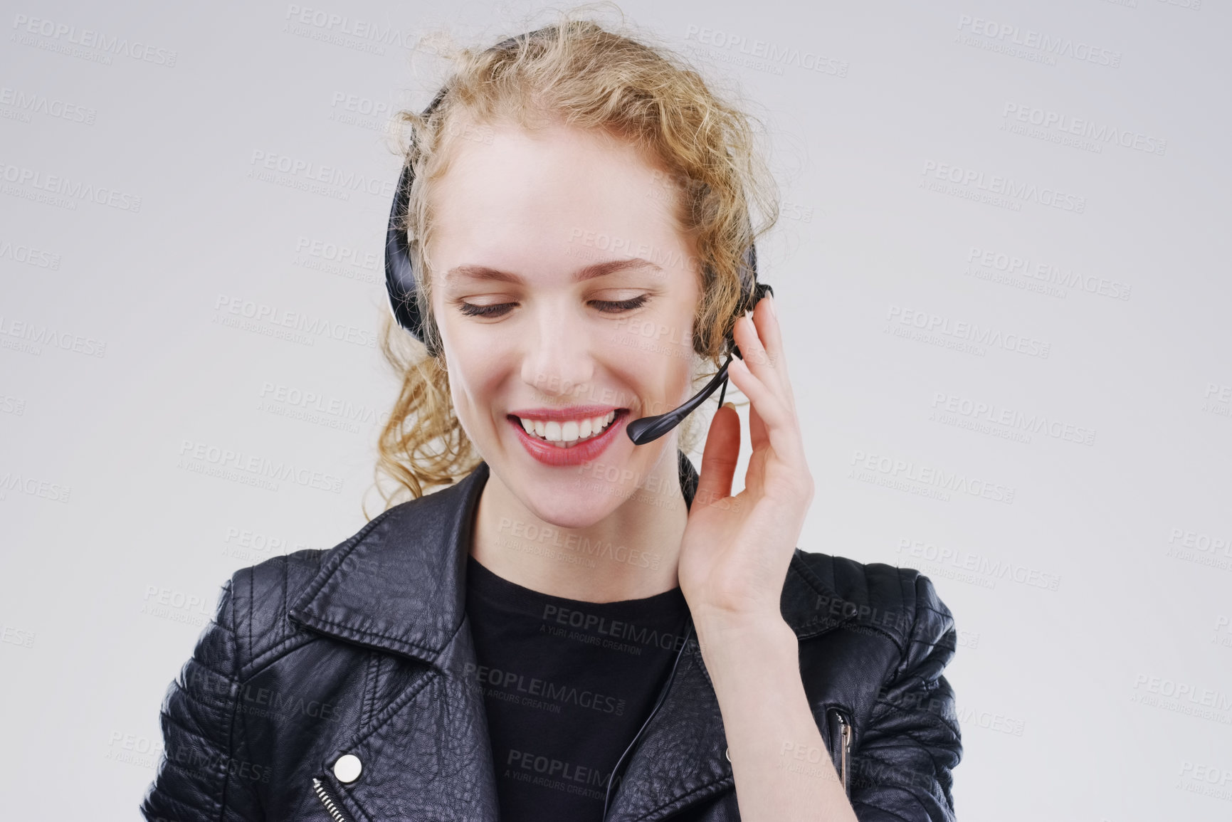 Buy stock photo Call center, woman and listening in studio with headset, smile or thinking for tech support by white background. Crm girl, telemarketing and help desk with microphone, voip and happy for consulting