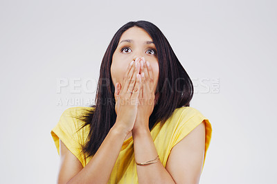 Buy stock photo Studio shot of a young woman looking shocked against a grey background