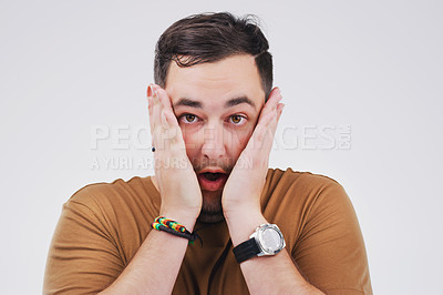 Buy stock photo Studio shot of a young man looking shocked against a grey background