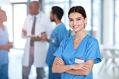 Buy stock photo Portrait of a young medical practitioner standing with her arms crossed in a hospital
