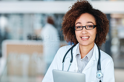 Buy stock photo Portrait of a young doctor using a digital tablet in a hospital