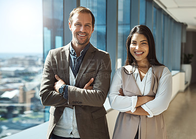 Buy stock photo Portrait of two businesspeople standing with their arms crossed in an office