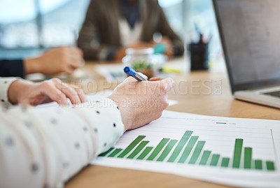 Buy stock photo Shot of unrecognizable businesspeople analyzing graphs in an office