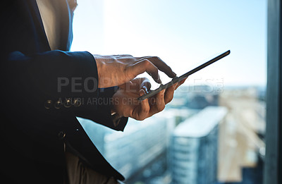 Buy stock photo Shot of an unrecognizable businessman using a digital tablet in an office
