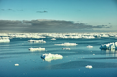 Buy stock photo Beautiful landscape of the calm sea with ice on a cold winter day with a blue sky and copy space. Small iceberg in the ocean outdoors in nature in the North Atlantic. West coast of Greenland