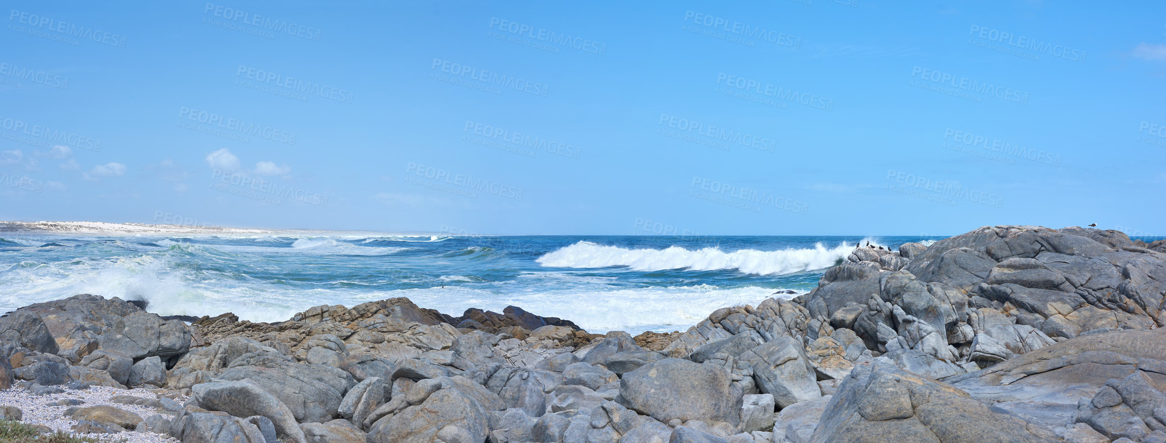 Buy stock photo Rocky coastline against blue horizon at sunset in South Africa. Peaceful and scenic landscape of boulders in the calm ocean water near Cape Town. Quiet location for summer vacation with copyspace