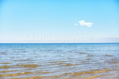 Buy stock photo Beach with a blue sky and copy space on a summer day. Peaceful and scenic view of the ocean seascape with copyspace. Calm empty sea landscape at low tide outdoors in nature 