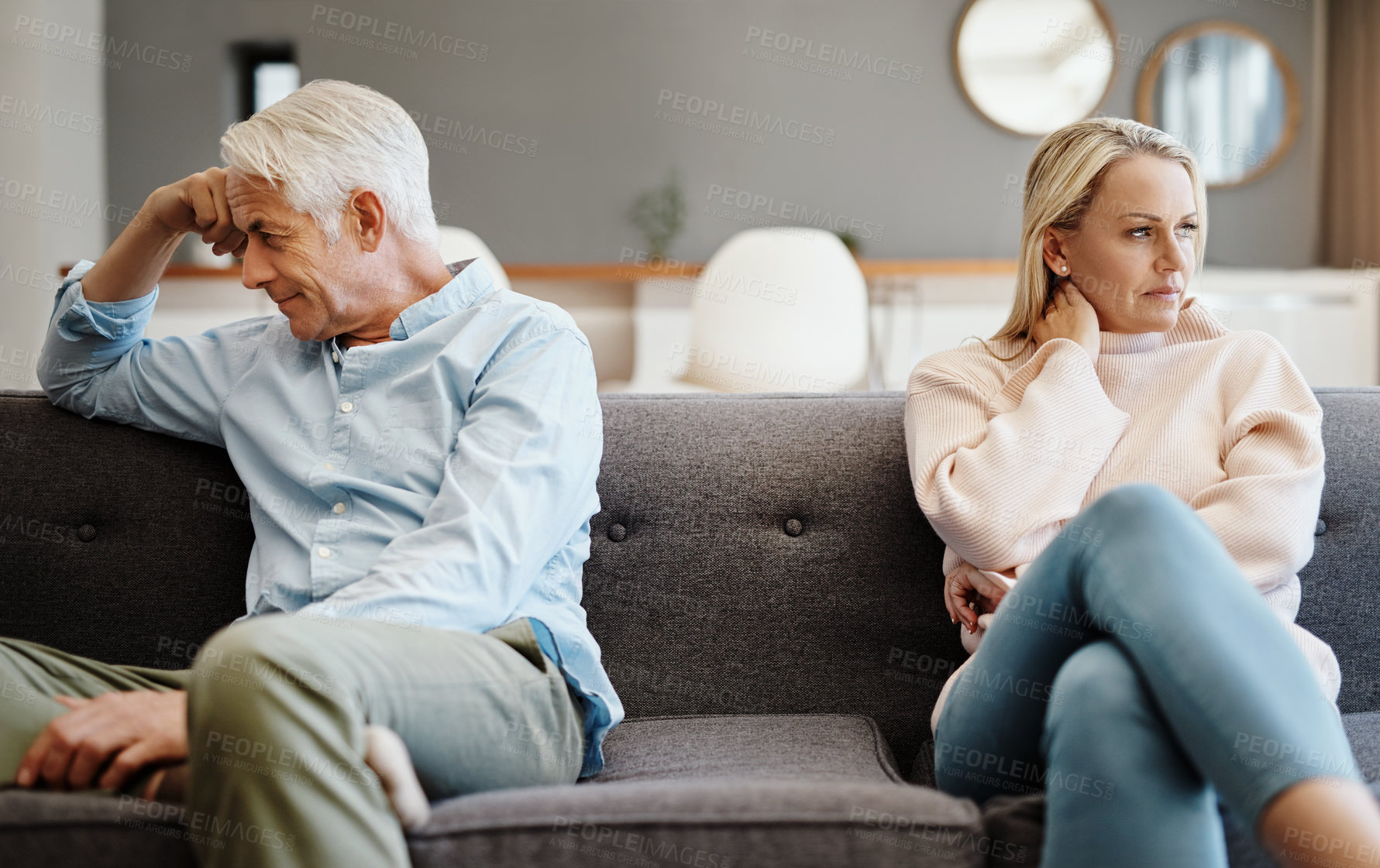 Buy stock photo Shot of a mature couple having a disagreement at home