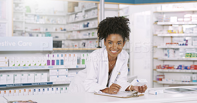Buy stock photo Portrait of an attractive young pharmacist making notes from a box of medication