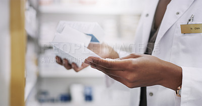Buy stock photo Closeup shot of an unrecognizable young pharmacist filling a prescription in a chemist