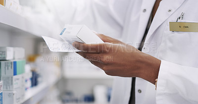 Buy stock photo Closeup shot of an unrecognizable young pharmacist filling a prescription in a chemist