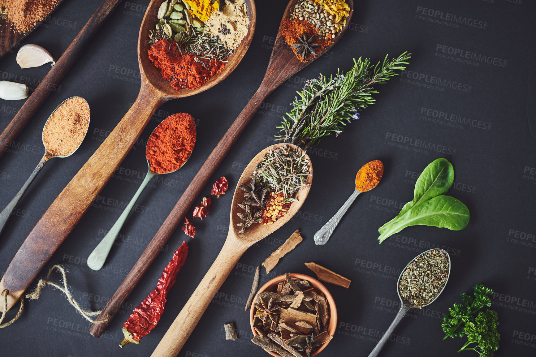 Buy stock photo Kitchen, curry and spices with spoon for culinary ingredients, flavor and seasoning on counter for cooking. Seeds, leaves and above table for meal prep, herbs and variety for food at restaurant