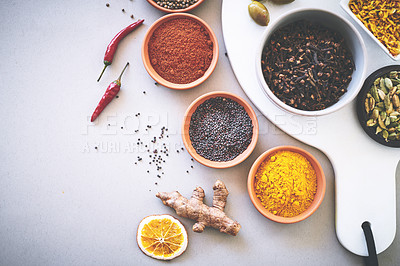 Buy stock photo Bowl, curry and board in gray background for spices, powder and sensory appeal for creativity with culinary. Studio, condiment and seasoning for cooking with ginger, aroma and ingredients collection