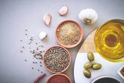 Buy stock photo Bowl, herbs and board in gray background for spices, powder and sensory appeal for creativity with culinary. Studio, condiment and flavor for cooking with ingredients, aroma and seasoning collection