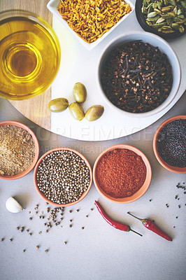 Buy stock photo Bowl, olives and board in gray background for spices, powder and sensory appeal for creativity with culinary. Studio, condiment and flavor for cooking with ingredients, aroma and seasoning collection