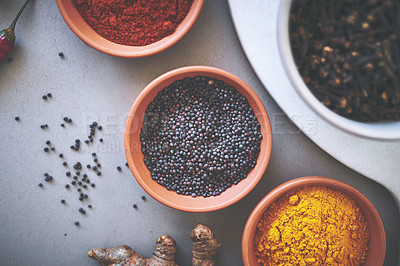 Buy stock photo Above, bowl and pepper in gray background for spices, powder and variety for sensory appeal with culinary. Studio, condiment or flavor for cooking with ingredients, texture or seasoning collection