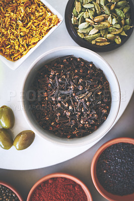 Buy stock photo Top view, bowl and clove in gray background for spices, powder and variety for sensory appeal with culinary. Studio, condiment and flavor for cooking with ingredients, texture or seasoning collection