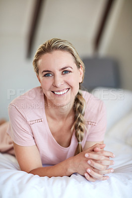 Buy stock photo Portrait of an attractive young woman relaxing on her bed in her bedroom at home