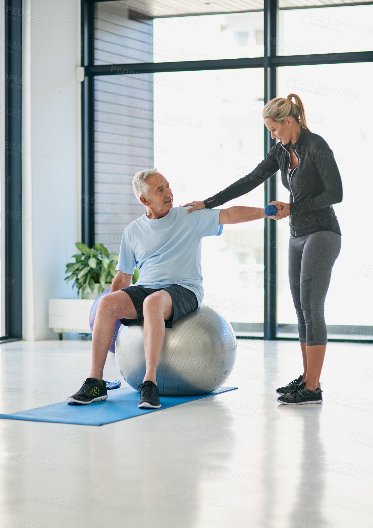 Buy stock photo Fitness, old man and physiotherapist with dumbbell for workout, stretching and healing for arm injury. Rehabilitation, senior patient and woman with weight for physiotherapy, muscle recovery and ball