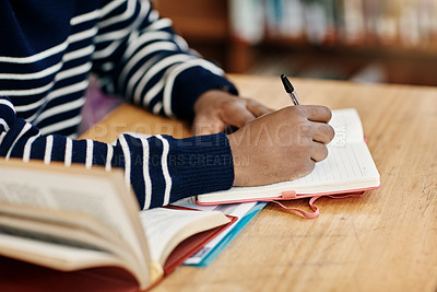 Buy stock photo Hands, student and writing with book in library for education, development or ready for exam. Person, notebook and pen for reminder, scholarship or research in study hall for assessment at university