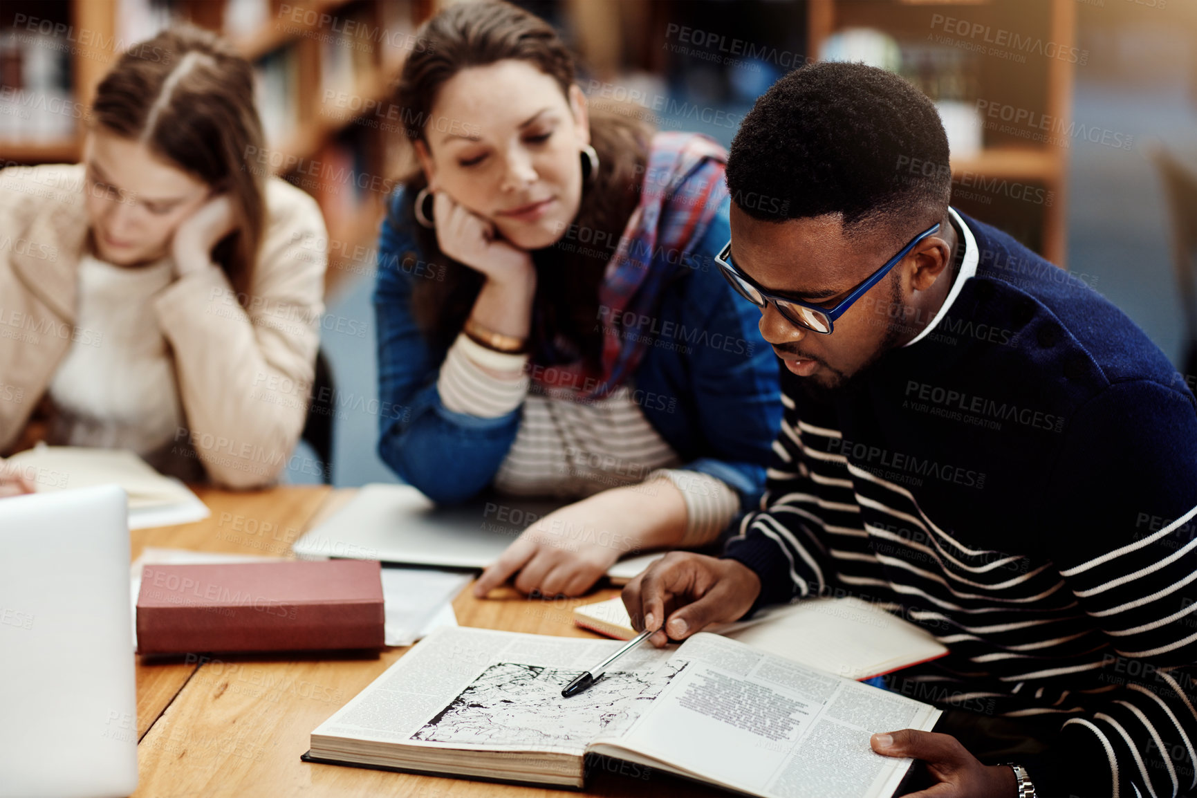 Buy stock photo Library, people and studying with book, research and reading for exam, woman and man in campus of college. Students, friends and teamwork for test, information and table with project and together