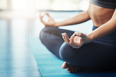 Buy stock photo Cropped shot of an unrecognizable young woman practicing yoga in her bedroom in the morning