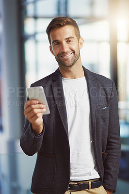 Buy stock photo Cropped shot of a businessman using his cellphone at the office