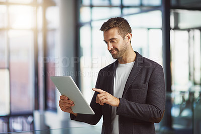 Buy stock photo Cropped shot of a businessman using a digital tablet at the office