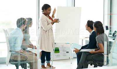 Buy stock photo Full length shot of a businesswoman giving a presentation during a meeting in the boardroom