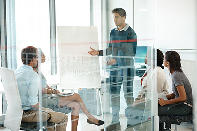 Buy stock photo Business people, presentation and man in meeting, leadership and brainstorming for project. Group, employees and presenter with diversity, coaching and board with review, workshop and feedback