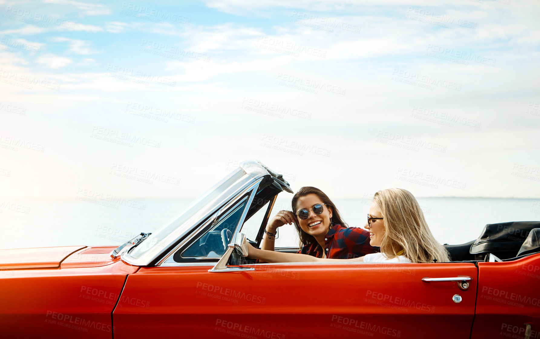 Buy stock photo Friends, woman and driving convertible for road trip, adventure and freedom or luxury on vacation. Portrait of excited people and young driver with license, car or cool vehicle for journey and travel