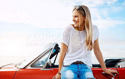 Buy stock photo Shot of a happy young woman enjoying a summer’s road trip