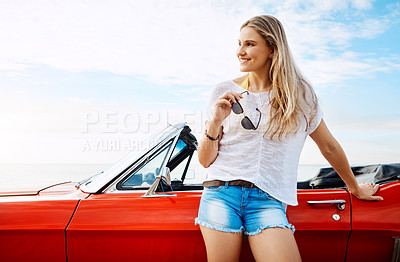 Buy stock photo Shot of a happy young woman enjoying a summer’s road trip