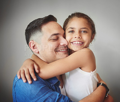 Buy stock photo Happy, father and daughter hug with love for affection, security and bonding together of relationship. Smile, girl and man with embracing for care, comfort and family connection on studio background