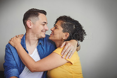 Buy stock photo Shot of an affectionate couple standing against a grey background