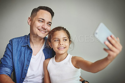 Buy stock photo Shot of a man taking a selfie with his young daughter