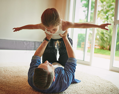 Buy stock photo Shot of a young girl and her father spending quality time together at home