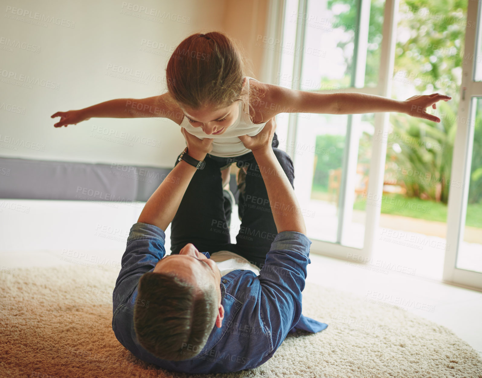 Buy stock photo Father, airplane and girl on floor, playful and lift for games, relax and bonding with love in family home. Dad, child and care with plane, fantasy and together on living room carpet at apartment