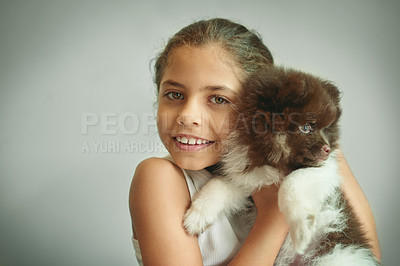 Buy stock photo Shot of a young girl posing with her puppy