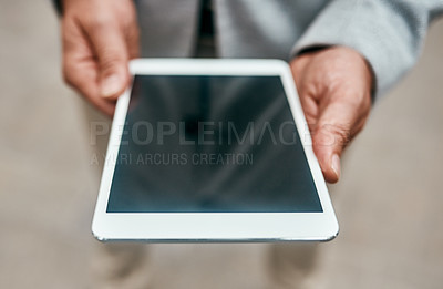 Buy stock photo Closeup shot of an unrecognizable businessman using a digital tablet outdoors