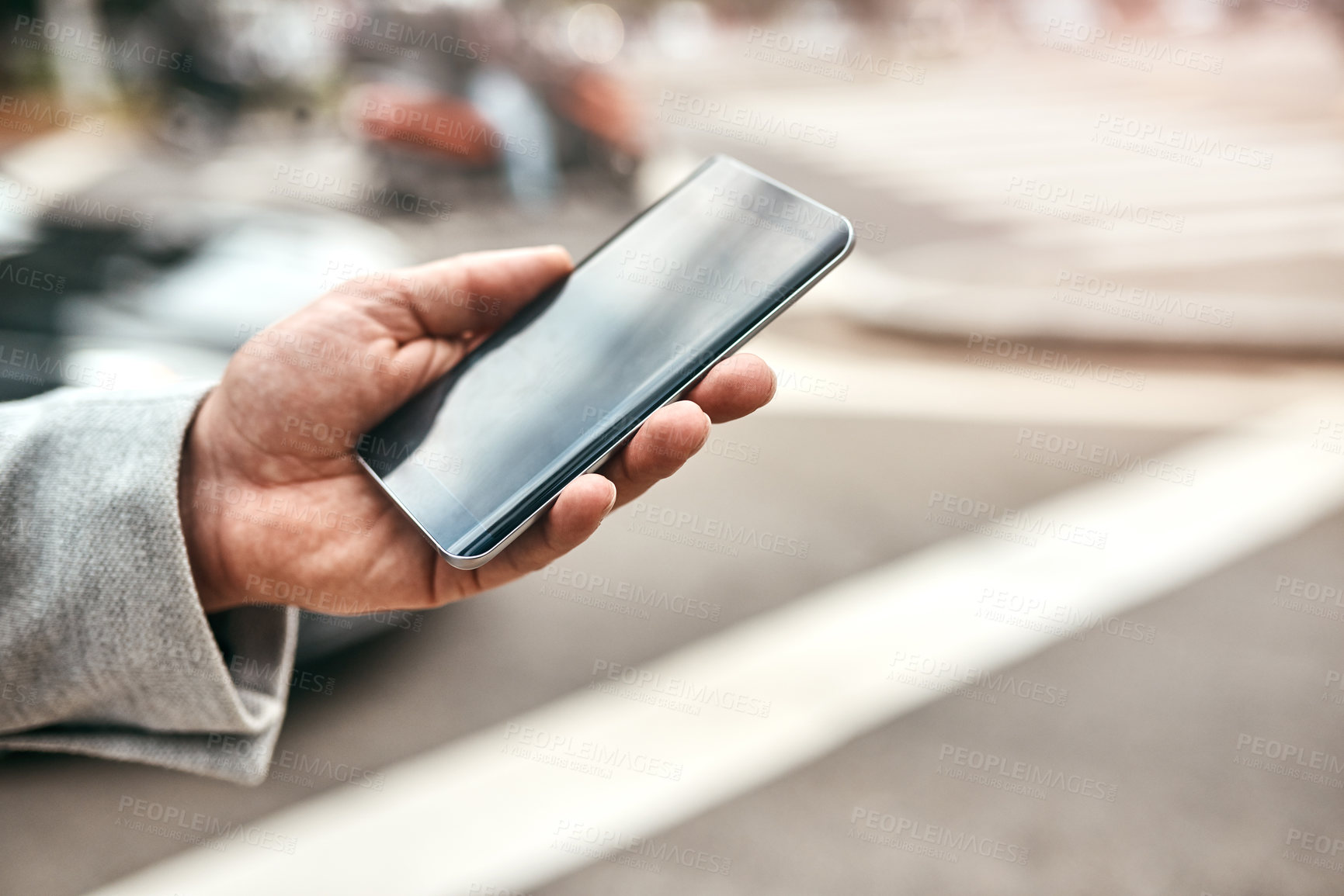 Buy stock photo Closeup shot of an unrecognizable businessman using a cellphone outdoors