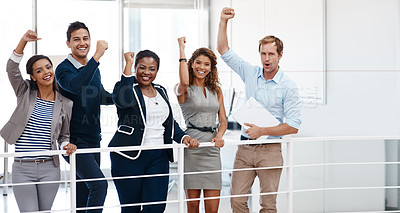 Buy stock photo Cropped shot of a diverse group of colleagues celebrating success with their arm raised at the office