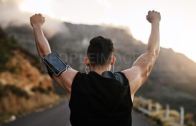 Buy stock photo Rearview shot of a sporty young man cheering while exercising outdoors