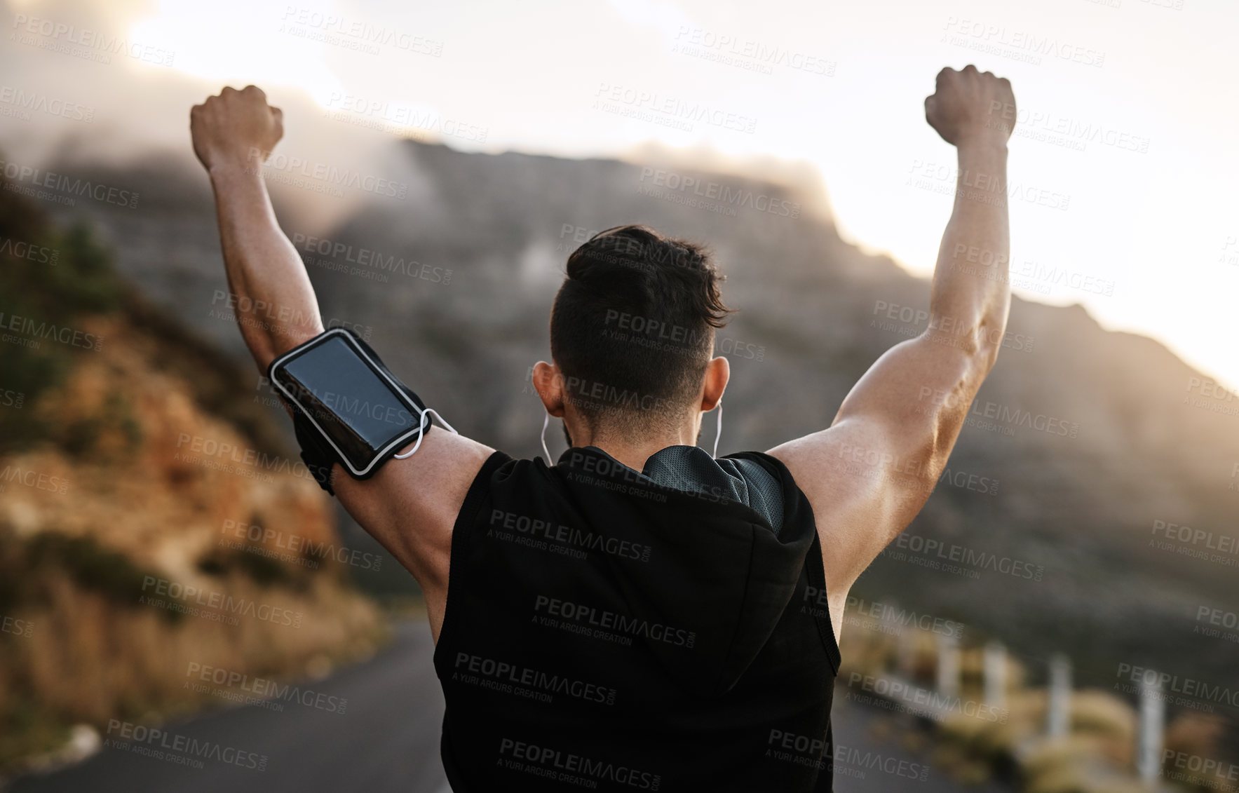 Buy stock photo Rearview shot of a sporty young man cheering while exercising outdoors