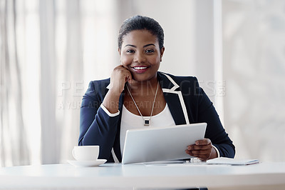 Buy stock photo Cropped portrait of an attractive young businesswoman looking thoughtful while working on her tablet in the office